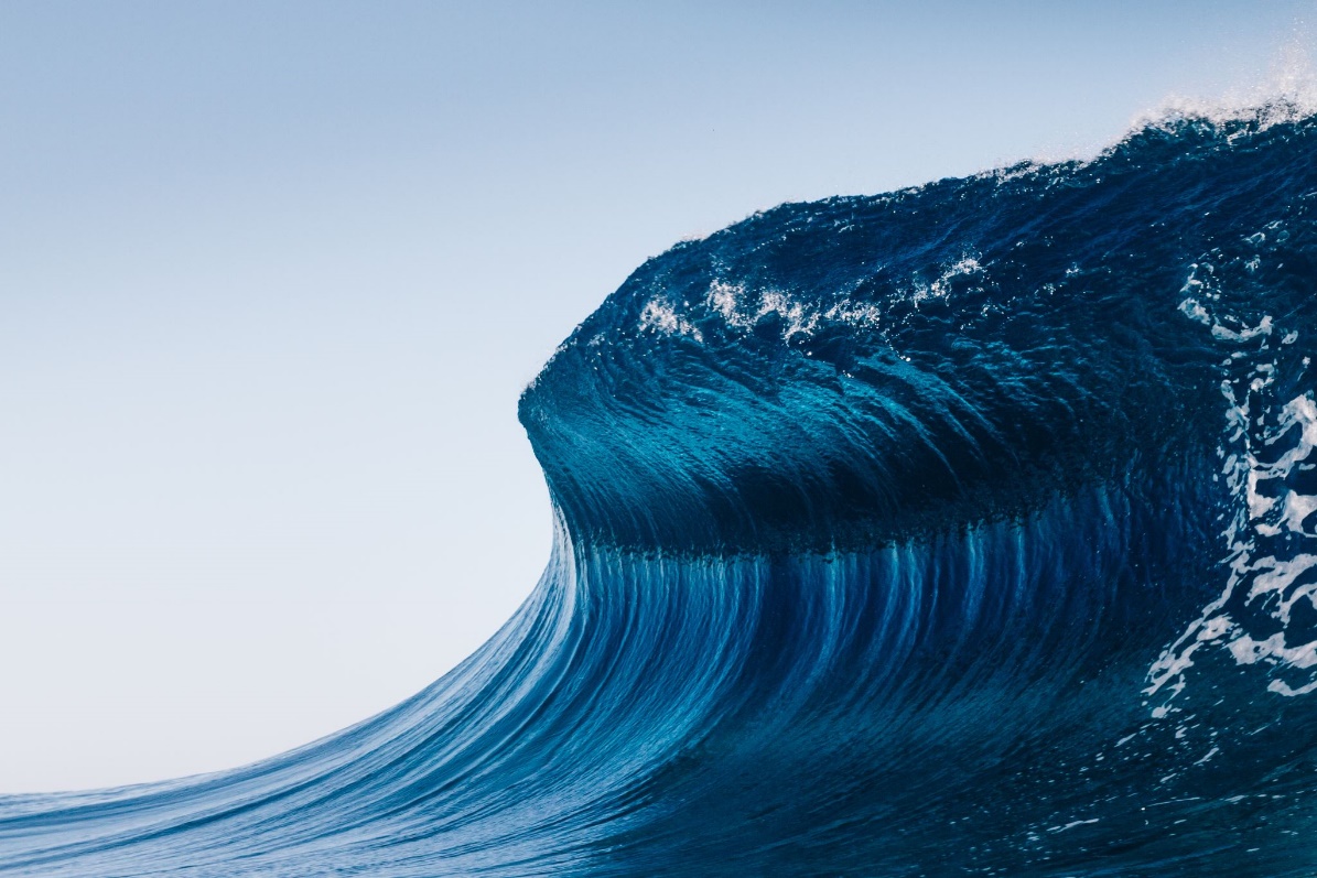 Large sea wave against a clear blue sky