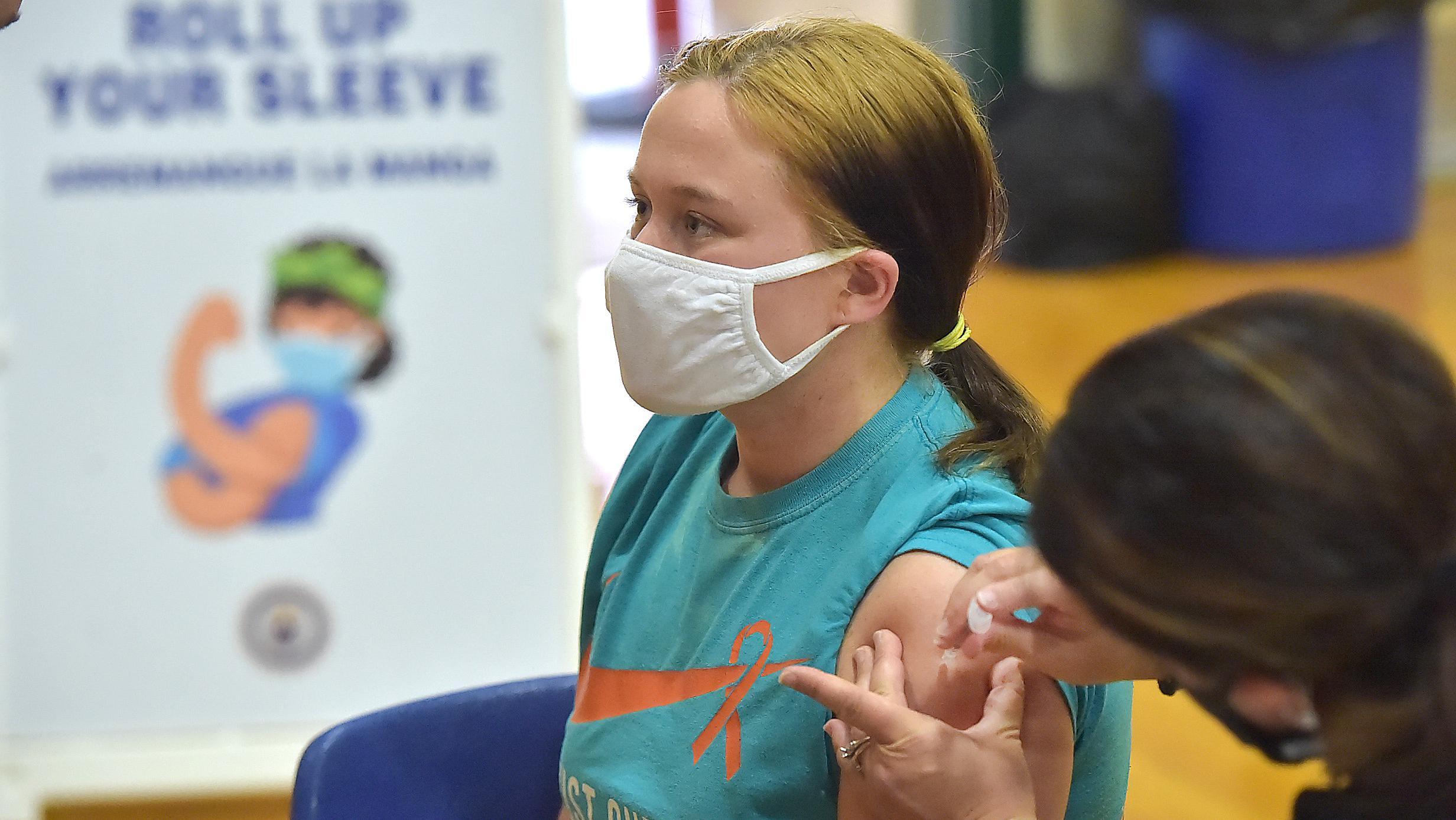 Teenage girl receiving a Covid vaccine. 